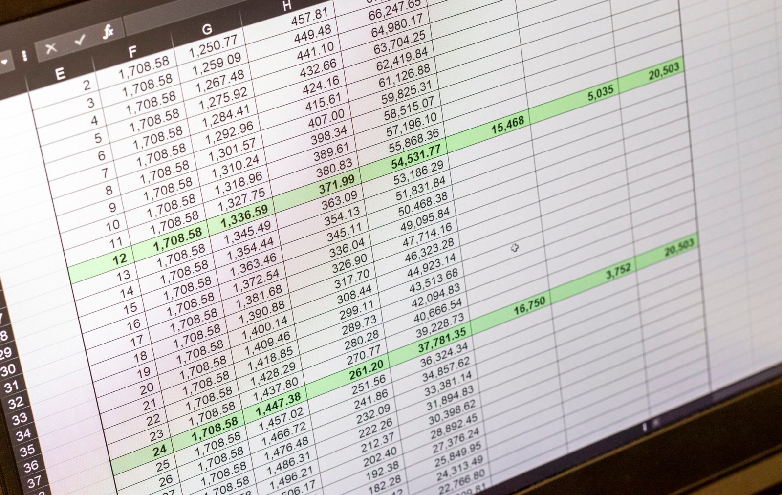 Shot of an dark mode excel sheet on computer screen showing bank loan amortization table.